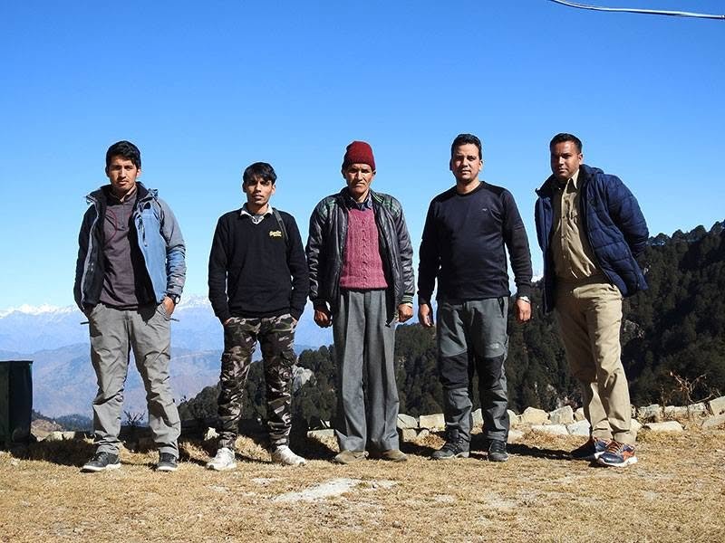 Survey team on high ridge of Shikari Devi with Himalayan range background